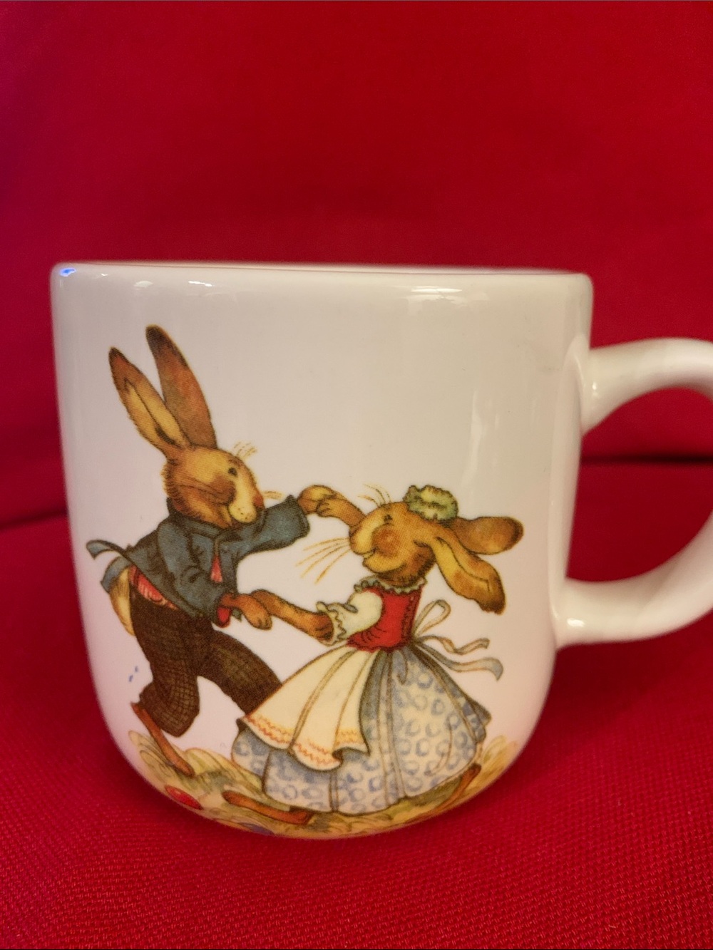 World Market white mug featuring dancing rabbits. 3.5 inches tall.
